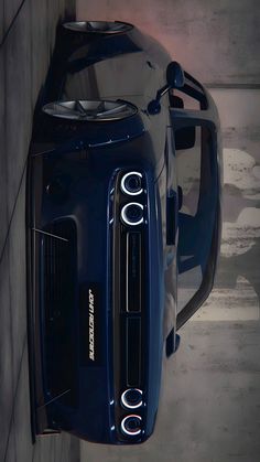 the front end of a blue sports car