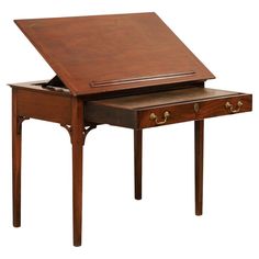 a wooden desk with an open drawer on top