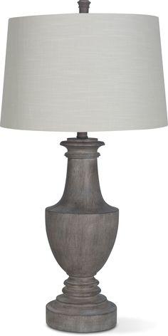 a gray lamp with a white shade on it's base and a light in the middle