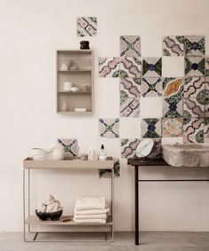 a bathroom with a sink, mirror and tile wallpaper on the walls behind it