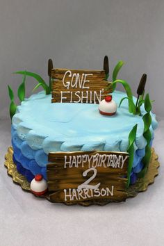 a birthday cake that is decorated to look like someones fishing on the lake and gone fishin happy birthday harrison