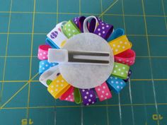 a pair of scissors sitting on top of some colorful hair clips with polka dots and bows