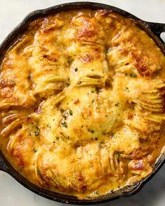 a casserole dish is shown in a cast iron skillet on a white surface