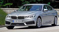 a silver bmw car driving down the road