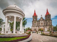 an old church with statues in front of it