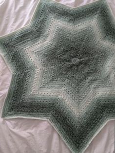 a crocheted blanket on top of a bed