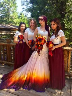 four bridesmaids pose for a photo on a deck with their bouquets in hand