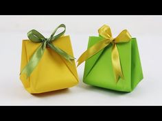 two origami boxes with bows on them