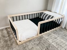 Black Montessori Floor Bed We want to make your toddlers transition from crib to bed easy and fun with our Sori Floor Beds! Our simple design keeps the safety of your child in mind and helps them feel safe and secure in a semi closed environment. Our beds will allow your child comfort and give them freedom of movement that can foster independence in their own space to help develop confidence. Our beds are not only great for your kiddos, but fantastic for those pre-bedtime snuggles with the famil Floor Beds, Montessori Floor Bed, Toddler Boys Room, Bed Dimensions, Floor Bed, Toddler Bedrooms, Big Boy Room, Feel Safe, Boy's Bedroom