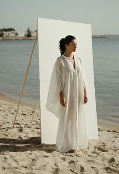 Gaia Linen Dress in White Elegant White V-neck Kaftan, White Relaxed Fit Maxi Dress For Loungewear, Chic White Flowy Kaftan, Elegant Summer Kaftan For Vacation, Elegant Summer Vacation Kaftan, White Oversized Maxi Dress, Elegant Beach Tunic For Spring, Elegant White Spring Tunic, Chic White Maxi Dress For Loungewear