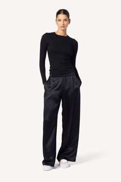 As if a wide-leg pant made of the smoothest silk wasn't enough, Brynn has pockets, too. A perfect addition to any wardrobe. Crafted from 100% pure silk, this wide-leg pant is both stylish and practical. The sewn-in waistband provides a comfortable and flattering fit, while the pockets add a touch of functionality. Designed for the modern woman, this pant is perfect for the office or a night out on the town. With its effortless elegance, the Brynn Silk Pant will quickly become a go-to in your clo Sleek Silk Wide Leg Pants, Sleek Wide-leg Silk Pants, Sleek Silk Wide-leg Pants, Elegant Black Viscose Pants, Silk Wide Leg Pants With Elastic Waistband For Work, Elegant Black Wide Leg Viscose Pants, Elegant Black Viscose Wide Leg Pants, Sleek Silk Wide Leg Bottoms, Black Viscose Wide Leg Pants