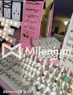 jewelry is displayed on a table in front of other items for sale at a store