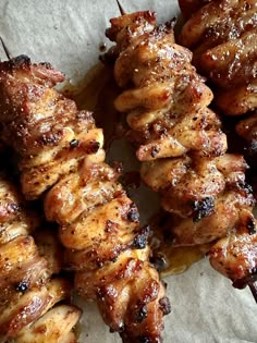 several skewers of meat sitting on top of each other