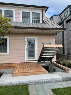 a house with a wooden deck and an open door