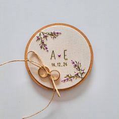 an embroidered wedding ring holder with the initials on it