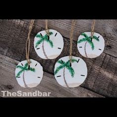 three handmade ornaments with palm trees on them