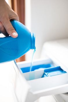 a person pouring water into a container