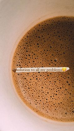 a cup of coffee with the words solution to all my problems written on it's side