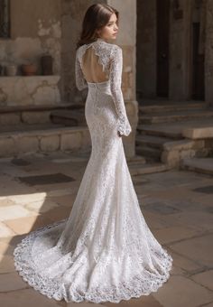 the back of a wedding dress with long sleeves and an open - back lace design