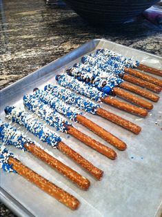 there are many blue and white sprinkles on the hot dog buns