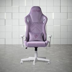 a purple office chair sitting on top of a white table next to a tiled wall