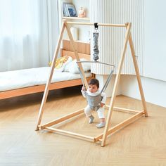 a small child is playing on a wooden frame