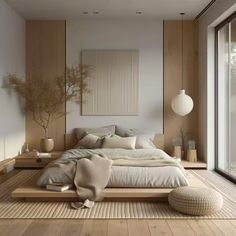 a large bed sitting on top of a wooden floor next to a tall glass window