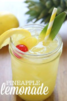 a pineapple lemonade in a mason jar with a straw and a cherry on top