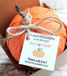 an orange pumpkin in a box with a card saying, boy or girl? which will it be?