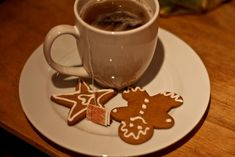 a cup of coffee and some cookies on a plate