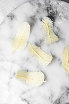 four pieces of butter on a marble plate