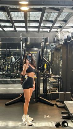 a woman taking a selfie in the gym