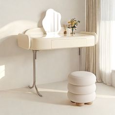 a white dressing table and stool in a room with curtains on the window sill