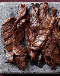 several pieces of meat sitting on top of a table