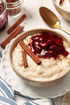 a bowl of oatmeal with cinnamon sticks and cranberry sauce