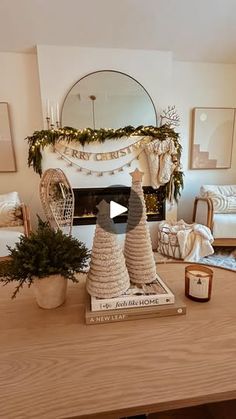 a living room filled with furniture and a fire place covered in christmas decorations on top of a wooden table