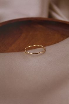 Effortlessly enhance your style with this dainty 14k Gold Wavy Ring. Extremely comfortable and lightweight. This stunning piece will give you a unique, hand-crafted and fresh new look. Whether its work or social, this ring will certainly compliment the occasion! Wear independently or stacked with other rings! Details * Handmade and designed using 14K Gold Filled * Designed and produced using the highest quality and care, allowing for fantastic durability and sustainability. * Beautifully package Wavy Ring, Gold Wave Ring, Gold Stacking Ring, Ring Everyday, Bohemian Jewellery, Unique Jewelry Gifts, Zierlicher Ring, Wave Ring, Ring Simple