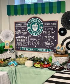 a table topped with lots of food next to a sign