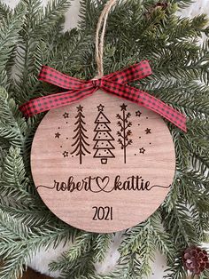 a personalized ornament hanging on a christmas tree