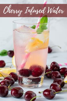 cherry infused water with lemon and mint garnish in a glass surrounded by cherries