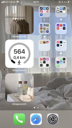 an iphone screen showing the home screen with various icons on it and in front of a window