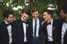 a group of men in suits and ties standing next to each other with their mouths open