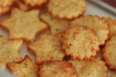 some crackers are on a white plate and have been cut into small pieces to look like stars