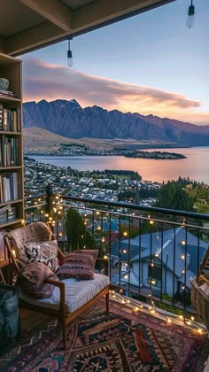 a balcony with a chair, bookshelf and lights on the floor next to it