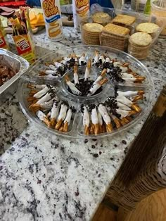 several trays of food sitting on a counter top next to other foods and condiments