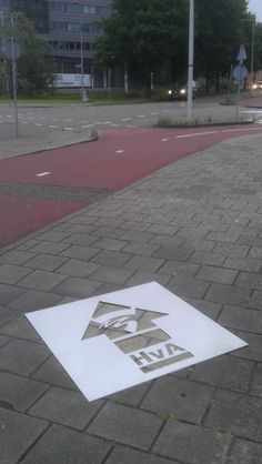 a white sign sitting on the side of a road