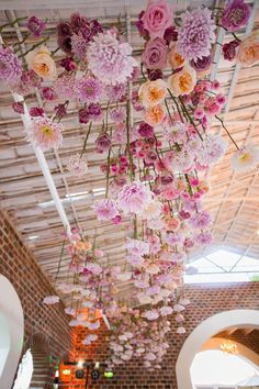 flowers hanging from the ceiling in a building