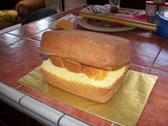 a loaf of bread sitting on top of a gold foil wrapper in front of a table