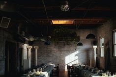 an empty restaurant with tables and chairs set up for formal dining, in the sunlight