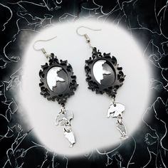 Step into the realm of whimsical and thought-provoking accessories with our captivating Broken Mirror Earrings, perfectly suited for those who revel in gothic style. These unique earrings are a testament to the beauty found in imperfection, inspired by the delicate balance between fragility and resilience. Crafted with care and attention to detail, each earring features a miniature hand mirror, its surface elegantly cracked and shattered, evoking an aura of mystery and allure. From the broken mi Black Fantasy Style Pierced Earrings, Black Fantasy Earrings, Black Fantasy Style Earrings, Black Gothic Drop Plug Earrings, Gothic Black Single Earring, Gothic Sterling Silver Earrings For Parties, Black Fantasy Dangle Jewelry, Fantasy Style Pierced Earrings For Party, Elegant Metal Halloween Earrings